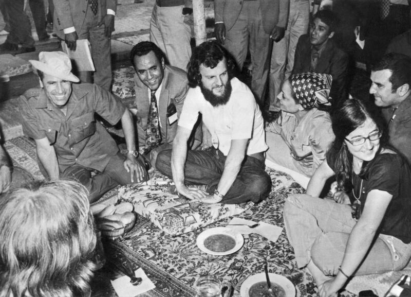 Picture dated July 1973 of Libyan Head of State Colonel Moamer Kadhafi (L) joking in Tripoli with a group of British hippies. Kadhafi, born in 1942, formed in 1963 the Free Officers Movement, a group of revolutionary army officers, which overthrew 01 September 1969 King Idris of Libya and proclaimed Libya, in the name of "freedom, socialism and unity," Socialist People's Jamahiriya.