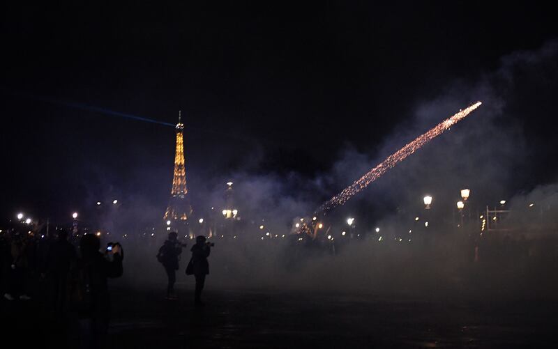 A protester's firework flies during a demonstration on Place de la Concorde in Paris, the day after the French government imposed a pensions age increase on the people. AFP
