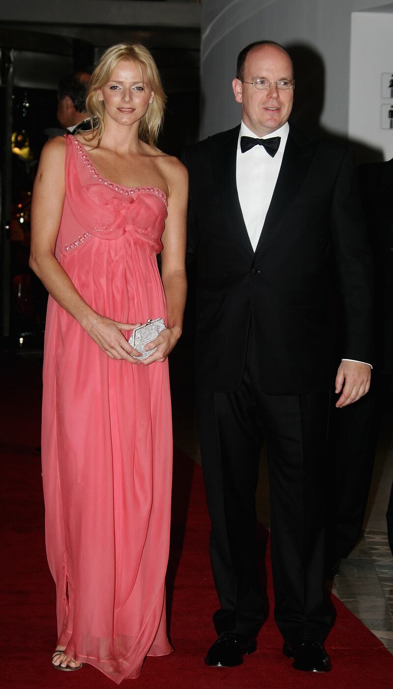 Charlene Wittstock, in a pink one-shouldered gown, and Prince Albert II of Monaco arrive at a gala dinner during the 2007 Monaco Formula One Grand Prix on May 27, 2007. Getty Images