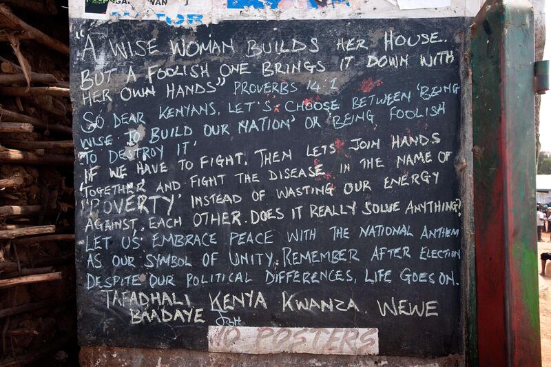 Graffiti promoting peace outside Ondugu Polling Station in the constituency of Kibera, Nairobi on March 4, 2013 during the nationwide elections. Long lines of Kenyans queued from far before dawn to vote Monday in critical elections, the first since violent polls five years ago, with five policemen killed in an ambush in Mombasa hours before polling started. The tense elections are seen as a key test for Kenya, with leaders vowing to avoid a repeat of the bloody 2007-8 post-poll violence in which over 1,100 people were killed, with observers repeatedly warning of the risk of renewed conflict.  AFP PHOTO / WILL BOASE

