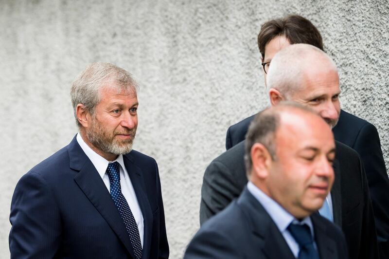 Russian oligarch Roman Abramovich, left, arrives with his team of lawyers before a hearing, at the District Court of Sarine in Fribourg, Switzerland, Friday, May 18, 2018. Russian billionaire and Chelsea soccer club owner Roman Abramovich was in Fribourg court as part of a lawsuit brought by the London-based European Bank for Reconstruction and Development (EBRD) against Abramovich, Russian oil tycoon Eugene Shvidler, and the Russian energy company Gazprom. (Jean-Christophe Bott/ Keystone via AP)