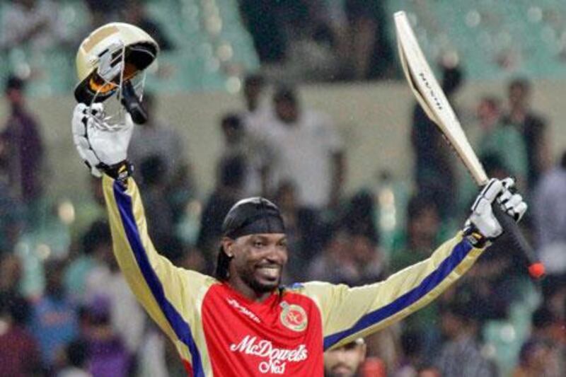Chris Gayle lifts his bat in the air in celebration after scoring a hundred for the Bangalore Royal Chargers yesterday which helped his side defeat the Kolkata Knight Riders.