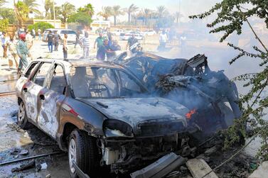 Libyans gather at the site of a car bomb attack in Libya's eastern city of Benghazi that killed three members of the UN mission. AFP