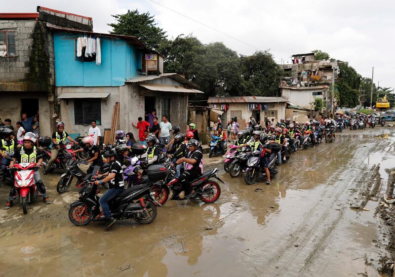 Filipino motorcycle riders lead a relief operation in the flood-hit Philippines.  EPA