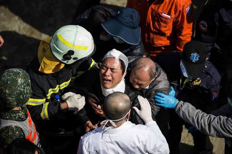 A man cries after his mother was confirmed dead near a collapsed building in Tainan, Taiwan. The government in Tainan, the worst-hit city, said that more than 170 people had been rescued from the 17-story building following the magnitude-6.4 quake that struck before dawn Saturday. Lam Yik Fei / Getty Images