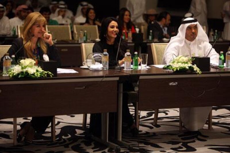 April 23, 2012 (Abu Dhabi) Doris Greif, left, Diana Haddad and Mohammed Al Dhaheri review presentations put on by the Abu Dhabi Ambassador program in Abu Dhabi April 23, 2013. (Sammy Dallal / The National)