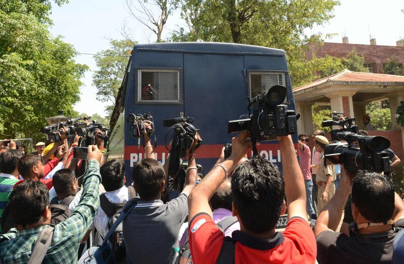 Media gather around a Punjab Police vehicle carrying the seven accused for the rape and murder of an eight-year-old nomadic girl in Kathua in Jammu and Kashmir, as verdict is expected to be delivered at the district court in Pathankot on June 10, 2019. Seven Hindu men will be sentenced at a later date. They face a minimum of life imprisonment and a maximum of death penalty. An eighth person allegedly involved, a juvenile, faces a separate trial. / AFP / NARINDER NANU
