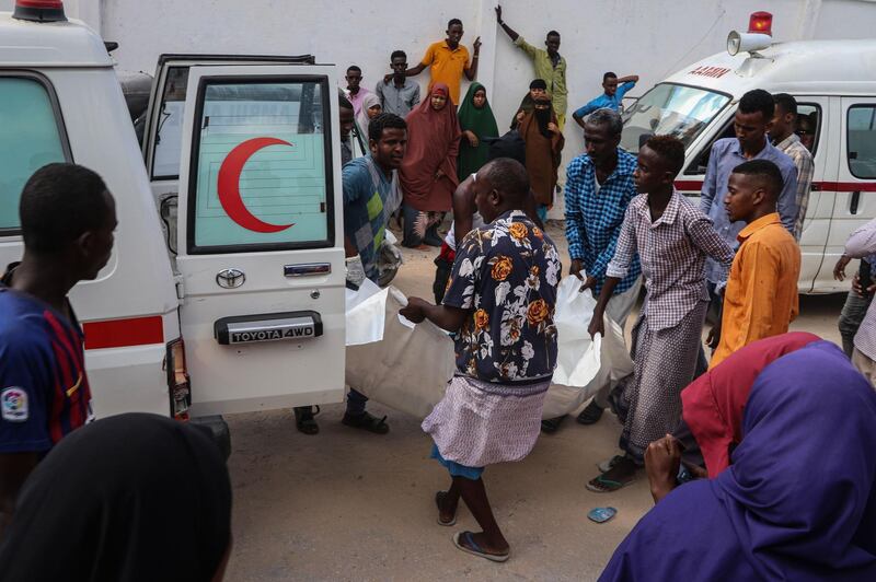 Men help to unload a victim who was injured during a car bombing attack, at the Madina Hospital. AFP