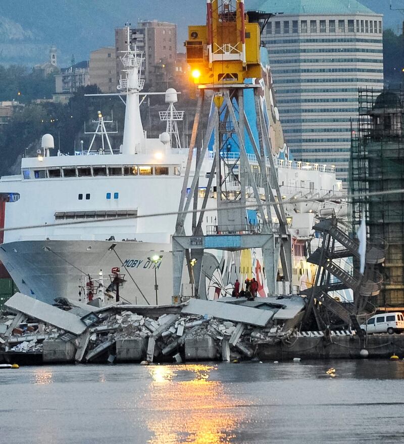 Rescuers search what is left of the control tower of the port of Genoa, northern Italy, after it collapsed when a cargo ship slammed into it killing at least three people, Tuesday, May 7, 2013. A half-dozen people remain unaccounted for early Wednesday, after a cargo ship identified as the Jolly Nero of the Ignazio Messina & C. SpA Italian shipping line, slammed into the port. (AP Photo/Francesco Pecoraro) *** Local Caption ***  Italy Cargo Ship Crash.JPEG-018f1.jpg