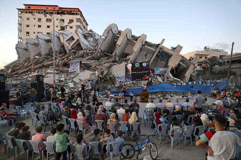 Palestinian  musicians perform on the rubble of the Hanadi Tower during an event organised by the Palestinian Committee for Youth and Culture in Gaza City. AFP