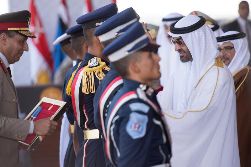 EL HAMAM, MATROUH GOVERNORATE, EGYPT - July 22, 2017: HH Sheikh Mohamed bin Zayed Al Nahyan, Crown Prince of Abu Dhabi and Deputy Supreme Commander of the UAE Armed Forces (R), presents a medal to graduating students of the Egyptian Armed Forces military colleges, during the inauguration of the Mohamed Naguib Military Base.

( Rashed Al Mansoori / Crown Prince Court - Abu Dhabi )
---