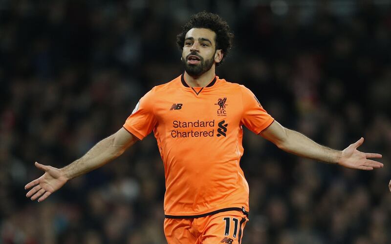 Liverpool's Egyptian midfielder Mohamed Salah  celebrates scoring the second goal during the English Premier League football match between Arsenal and Liverpool at the Emirates Stadium in London on December 22, 2017. (Photo by Ian KINGTON / AFP) / RESTRICTED TO EDITORIAL USE. No use with unauthorized audio, video, data, fixture lists, club/league logos or 'live' services. Online in-match use limited to 75 images, no video emulation. No use in betting, games or single club/league/player publications. / 