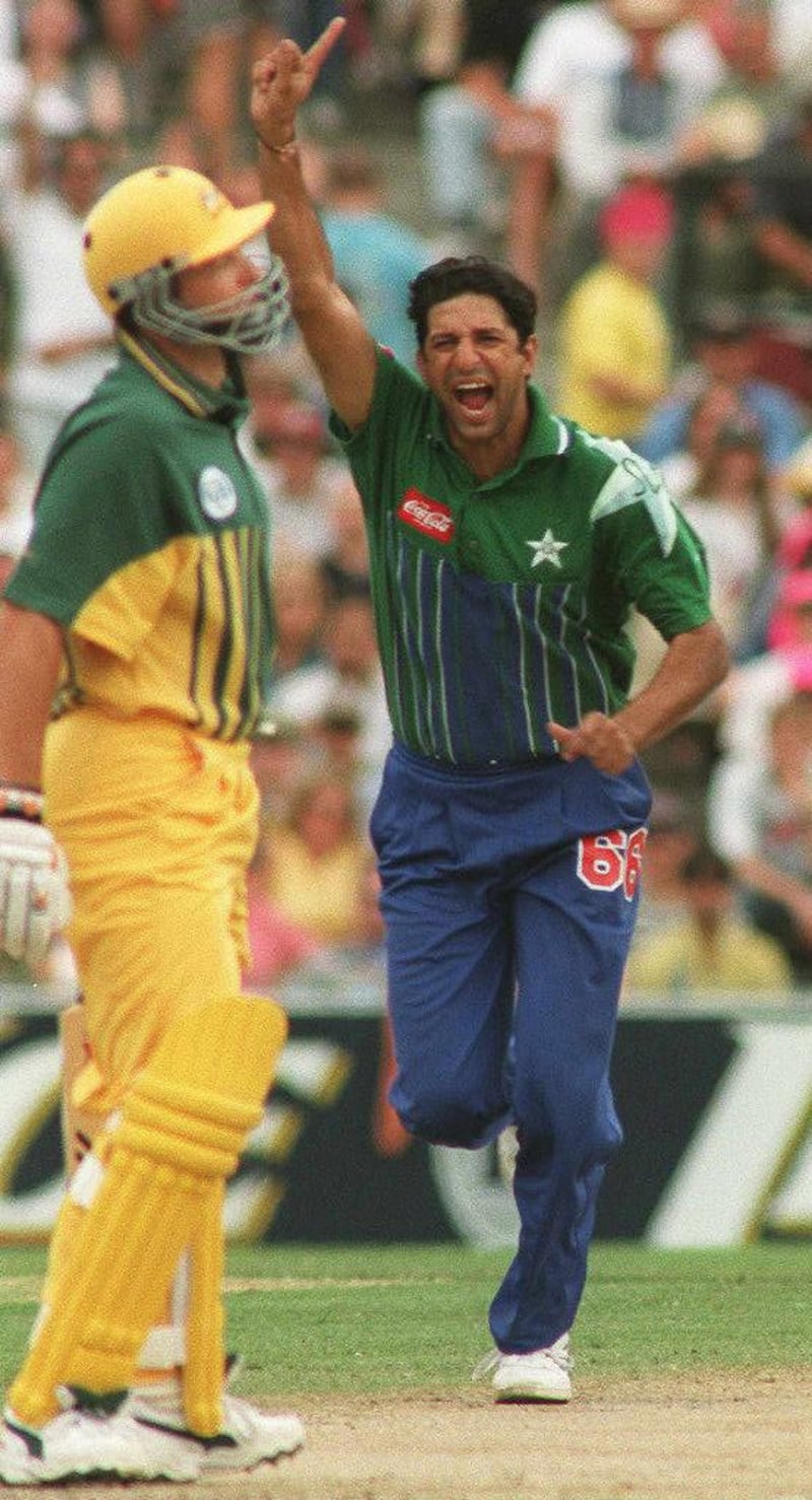 Pakistan's captain and fast bowler Wasim Akram (R) jubilates after claiming the wicket of Australian opening batsman Mark Waugh (L) during the one-day World Series International in Sydney 01 Januaury 1997. AFP PHOTO. (Photo by - / AFP)