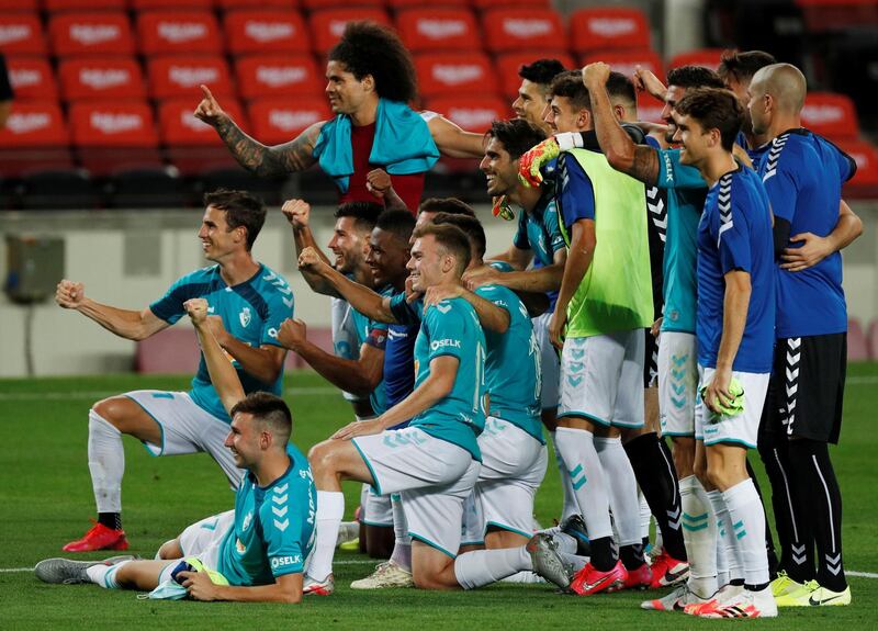 Osasuna players celebrate their win over Barcelona at Camp Nou. Reuters