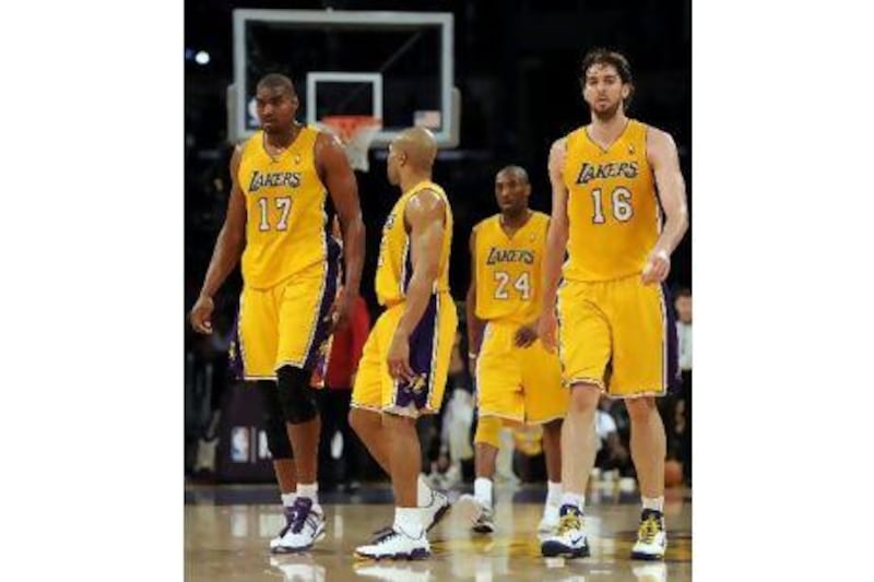 Derek Fisher, second left, Kobe Bryant, in background, and Pau Gasol, right, are just three of the eight players the Los Angeles Lakers have on their roster who are the wrong side of 30. Harry How / Getty Images
