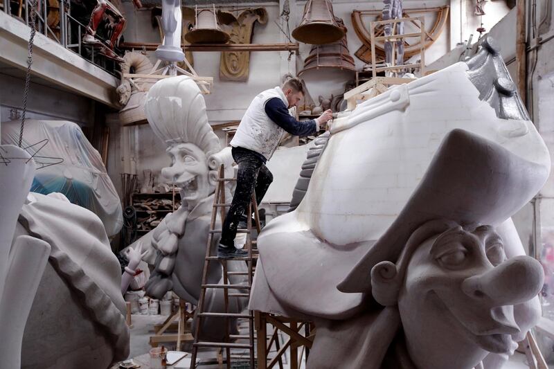 A craftsman works on a falla papier-mache sculpture in his workshop, despite the Fallas festival in Valencia, Spain, being suspended for the second year due to the coronavirus pandemic. EPA