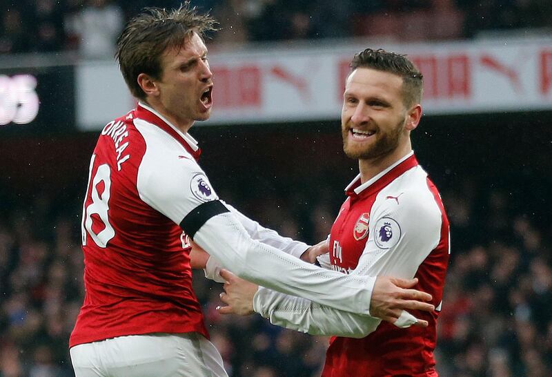 Arsenal's Nacho Monreal, left, celebrates with teammate Shkodran Mustafi after scoring their side's first goal during the English Premier League soccer match between Arsenal and Crystal Palace at the Emirates stadium in London, Saturday, Jan. 20, 2018.(AP Photo/Frank Augstein)