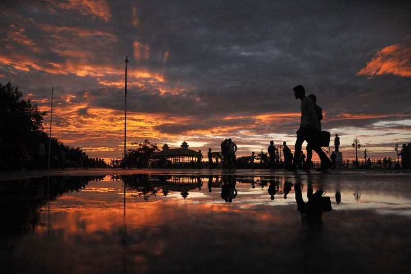 Pedestrians walk during sunset after heavy rainfall in Shimla, northern India. AFP Photo