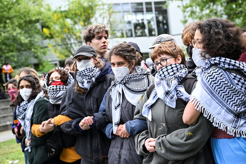 Pro-Palestine demonstrators form a human chain at the institution, known in German as Freie Universitat. Reuters