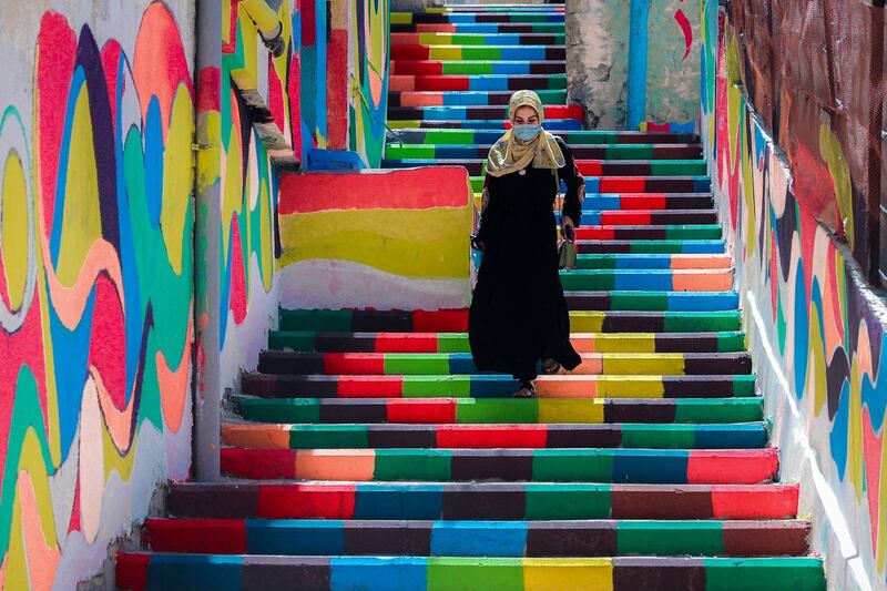 A Palestinian woman walks down brightly coloured steps in the old Al-Daraj neighbourhood of Gaza city. AFP