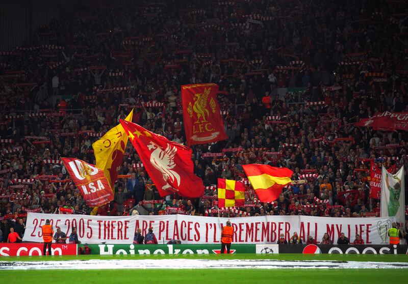 Liverpool fans in the stands show their support at Anfield.