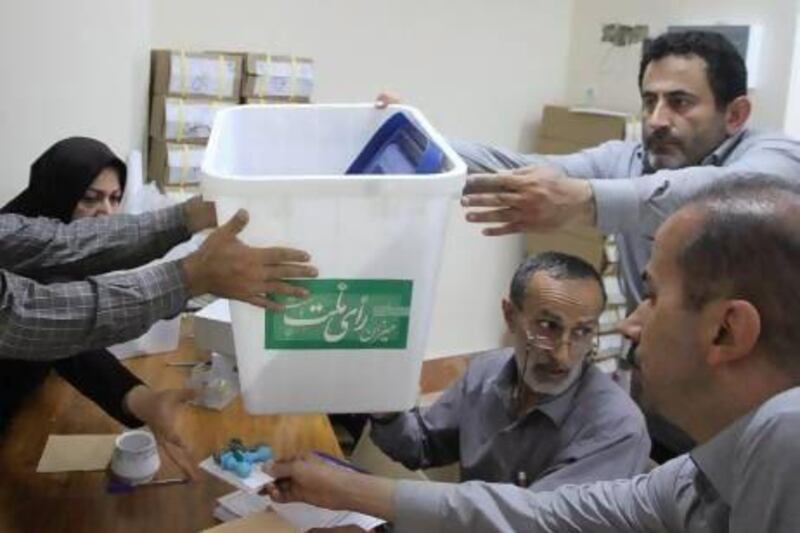 Officials prepare ballot boxes for Friday's presidential and city council elections in Amol, northern Iran. Behrouz Khosravi / Fars News / Reuters