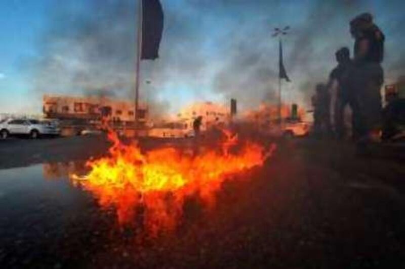 epa01617292 Protesters set fire to the road during a rally in Jid Hafs village on the outskirts of the Bahraini capital Manama 28 January 2009. Tension over the 26 January 2009 arrest of three Bahraini Shiite opposition figures continued to mount in the Gulf island, sparking further criticism from opposition groups and a third day of straight clashes between supporters of the trio and police in most parts of the island.  EPA/MAZEN MAHDI