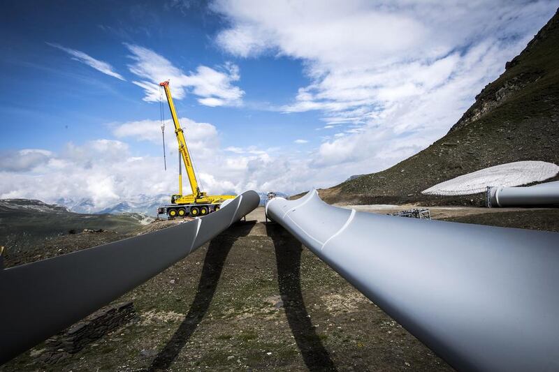 A crane at Griessee lake. The wind turbine blades are 45 metres in length and weigh about 11,000 kilograms.  Olivier Maire / EPA