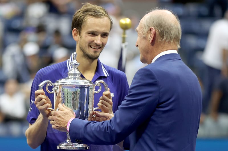 Daniil Medvedev of Russia is awarded the championship trophy by former tenner player Stan Smith after defeating Novak Djokovic of Serbi. AFP