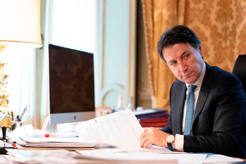 This photo taken and handout by the press office of Palazzo Chigi on March 26, 2020 shows Italian Prime Minister, Giuseppe Conte taking part from his office in Rome in a video conference as part of an extraordinary meeting of G20 leaders, during the country's lockdown following the COVID-19 new coronavirus pandemic.   Italian Prime Minister Giuseppe Conte is blocking a joint response that EU leaders are trying to put together to the coronavirus crisis, an Italian government source said on March 26. - RESTRICTED TO EDITORIAL USE - MANDATORY CREDIT "AFP PHOTO / PALAZZO CHIGI PRESS OFFICE" - NO MARKETING - NO ADVERTISING CAMPAIGNS - DISTRIBUTED AS A SERVICE TO CLIENTS
 / AFP / Palazzo Chigi press office / Handout / RESTRICTED TO EDITORIAL USE - MANDATORY CREDIT "AFP PHOTO / PALAZZO CHIGI PRESS OFFICE" - NO MARKETING - NO ADVERTISING CAMPAIGNS - DISTRIBUTED AS A SERVICE TO CLIENTS
