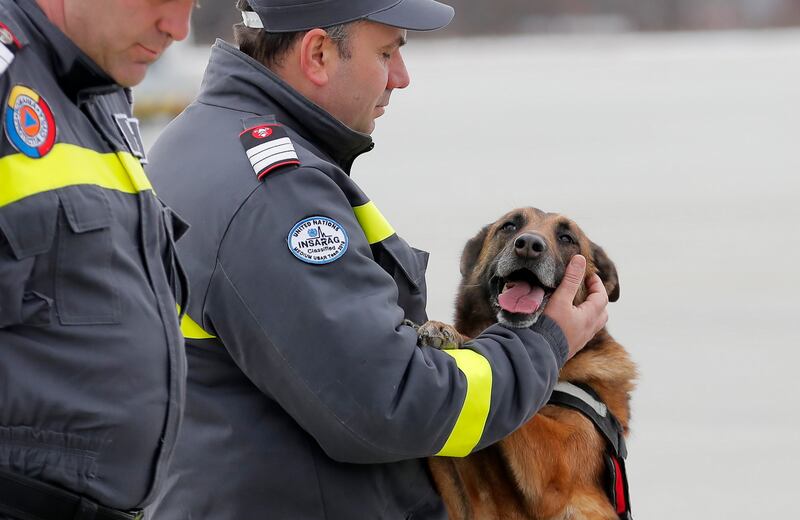 A Romanian rescue worker and search dog at a briefing before flying to southern Turkey to help local authorities in their rescue missions after the earthquake that hit Turkey and Syria.  EPA