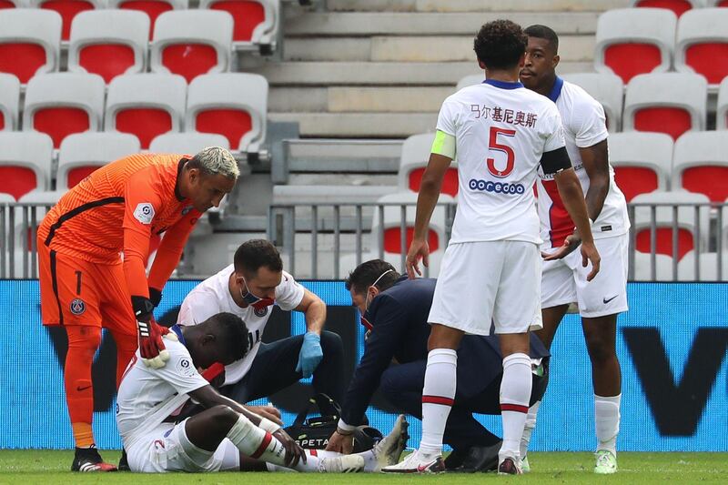 PSG's Idrissa Gueye is checked out by medical staff. AFP