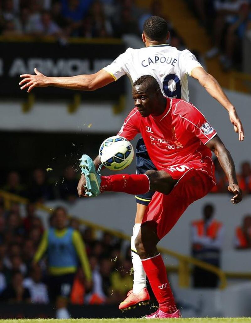 Liverpool's Mario Balotelli wins the ball from Tottenham Hotspur's Etienne Capoue during their Premier League match on Sunday. Eddie Keogh / Reuters