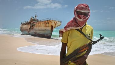 A Somali pirate stands in front of hijacked Taiwanese fishing vessel. Shipping experts have called for international navy co-operation to stop a surge in piracy in the Indian Ocean. AP