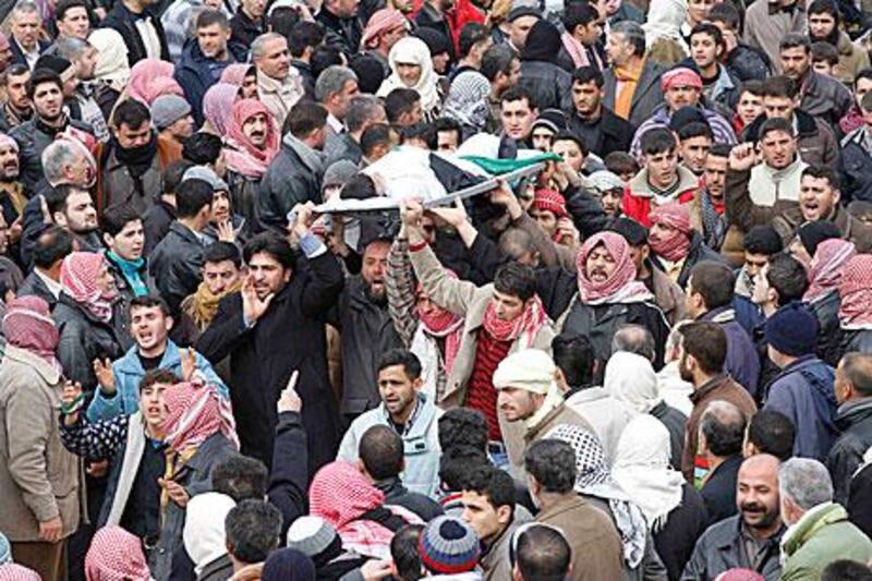Mourners carry the body of a 10-year-old boy during a funeral for the child and rebel fighters killed during fighting in Idlib.