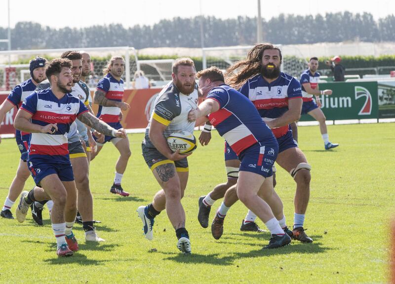 Dubai Hurricanes (grey/white shirts) take on Jebel Ali Dragons at The Sevens Stadium in Dubai. Ruel Pableo for The National