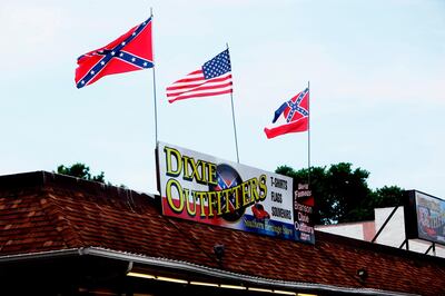 This June 21, 2020 photo shows Dixie Outfitters in Branson, Mo. Protesters have been gathering outside the strip mall store, which specializes in Confederate flags, clothing and other merchandise. The protests have drawn people from opposing sides of the debate â€” Black Lives Matter demonstrators, as well as those who support the store and the Confederate flag. (Sara Karnes/The Springfield News-Leader via AP)