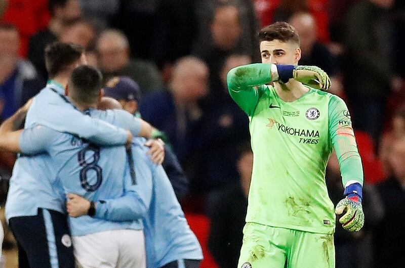 Soccer Football - Carabao Cup Final - Manchester City v Chelsea - Wembley Stadium, London, Britain - February 24, 2019  Chelsea's Kepa Arrizabalaga looks dejected as Manchester City players and staff celebrate winning the final   Action Images via Reuters/Carl Recine  EDITORIAL USE ONLY. No use with unauthorized audio, video, data, fixture lists, club/league logos or "live" services. Online in-match use limited to 75 images, no video emulation. No use in betting, games or single club/league/player publications.  Please contact your account representative for further details.