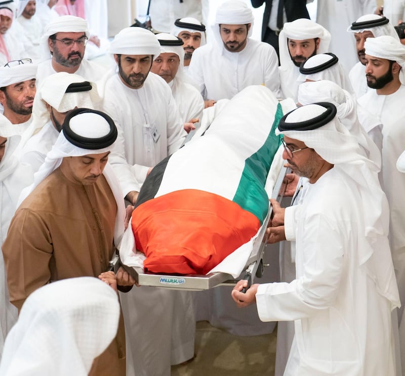 Sheikh Mansour bin Zayed, Deputy Prime Minister and Minister of Presidential Affairs, helps to carry his brother, Sheikh Sultan, from the mosque after funeral prayers. Wam