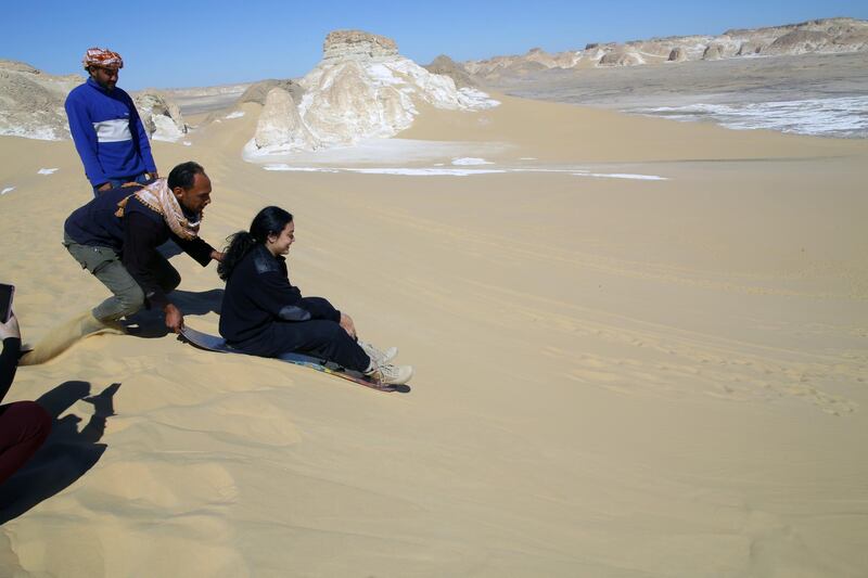 People skate on the sand at Maghrafa Mountain near Bawiti in Bahariya Oasis. EPA