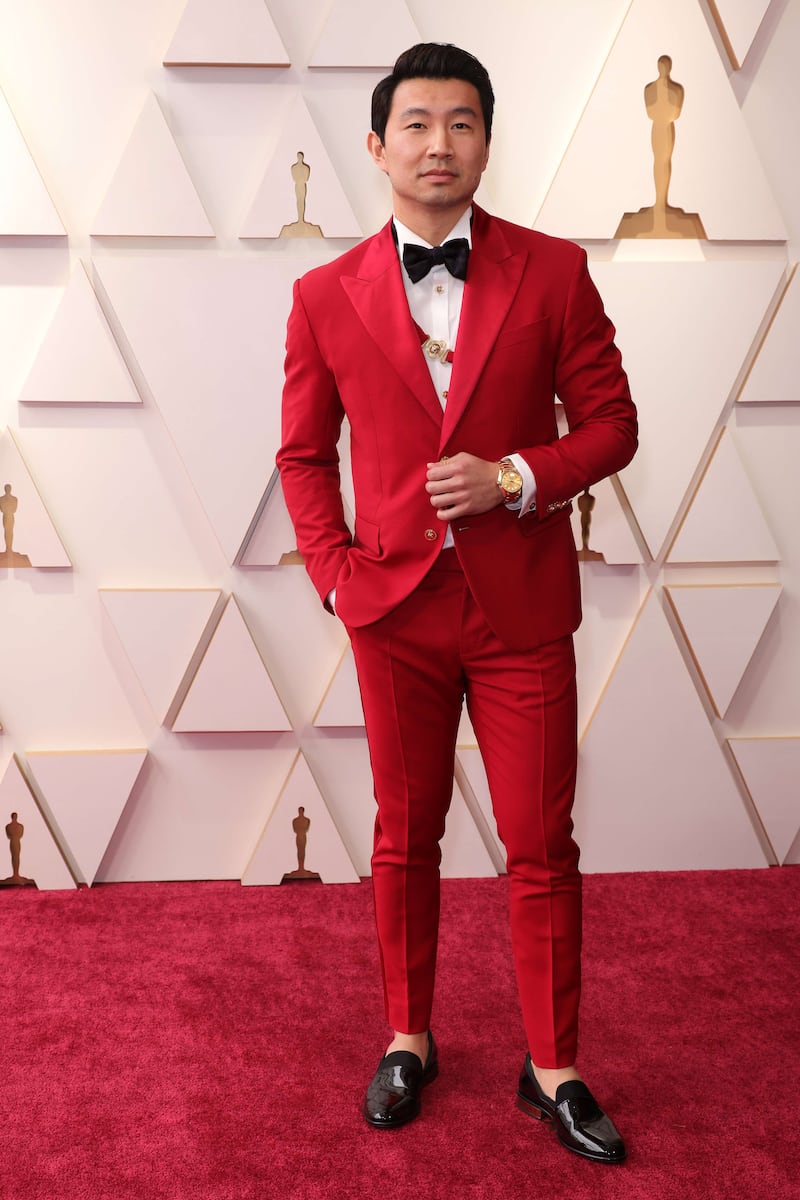 Canadian actor and Marvel movie star Simu Liu wears a red tuxedo. Getty