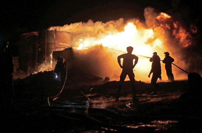 Members of the Syrian Civil Defence fight a fire which erupted after a bombardment of makeshift oil refining installations in the Tarhin area, near the Turkish-controlled city of Al Bab in the north of Aleppo province. AFP