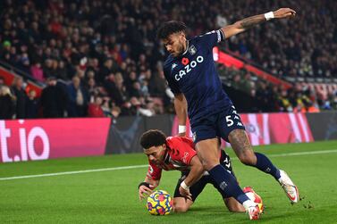 Southampton's English midfielder Che Adams is tackled by Aston Villa's English defender Tyrone Mings (R) during the English Premier League football match between Southampton and Aston Villa at St Mary's Stadium in Southampton, southern England on November 5, 2021.  (Photo by Glyn KIRK / AFP) / RESTRICTED TO EDITORIAL USE.  No use with unauthorized audio, video, data, fixture lists, club/league logos or 'live' services.  Online in-match use limited to 120 images.  An additional 40 images may be used in extra time.  No video emulation.  Social media in-match use limited to 120 images.  An additional 40 images may be used in extra time.  No use in betting publications, games or single club/league/player publications.   /  