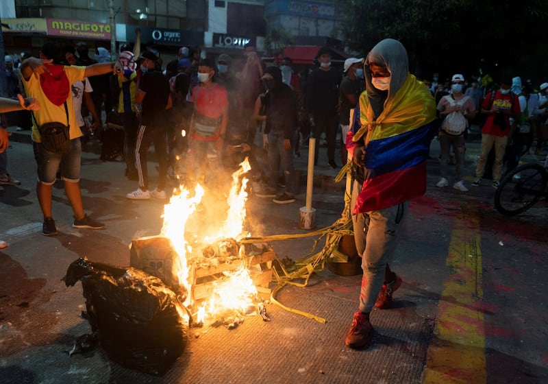 Demonstrators gather around a burning barricade during the match between America de Cali and Atletico Mineiro. Reuters
