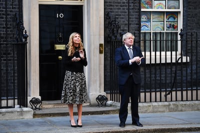 UK Prime Minister Boris Johnson and wife Carrie Symonds applaud for key workers outside 10 Downing Street on May 14, 2020. Leon Neal / Getty Images