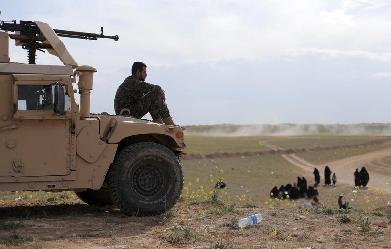 A fighter of Syrian Democratic Forces (SDF) sits on a vehicle near Baghouz, Deir Al Zor province, Syria. Reuters