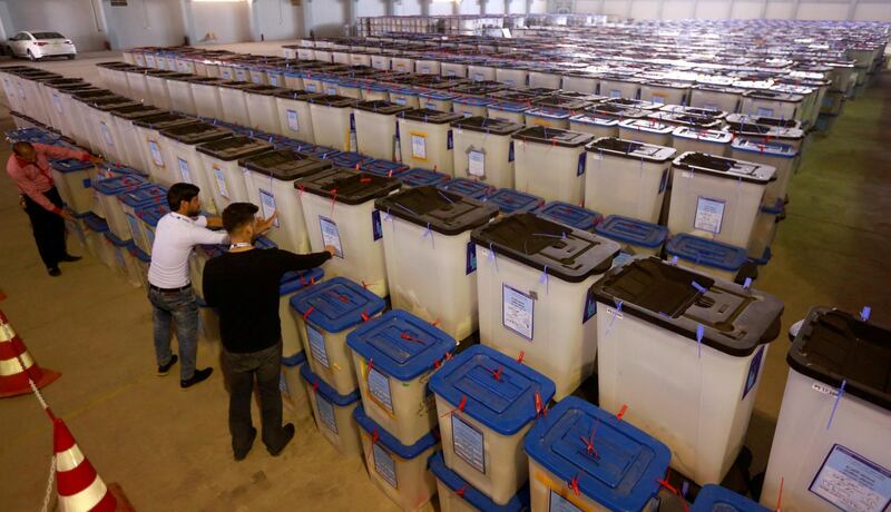 FILE PHOTO: Employees of the Iraqi Independent High Electoral Commission inspect ballot boxes at a warehouse in Najaf, Iraq May 15, 2018. REUTERS/Alaa al-Marjani/File Photo