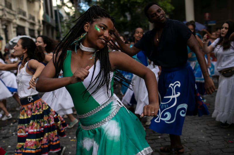 A woman dances during a rehearsal by the street carnival group 'Tambores de Olokun' in Rio de Janeiro. AP