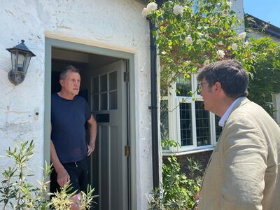 Paul Follows, Lib Dem candidate for Godalming and Ash, chatting to  Roger on his doorstep. Thomas Harding / The National