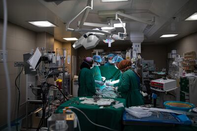 Doctors perform heart surgery in the operating theatre of Al Makassed Hospital. Corinna Kern for The National